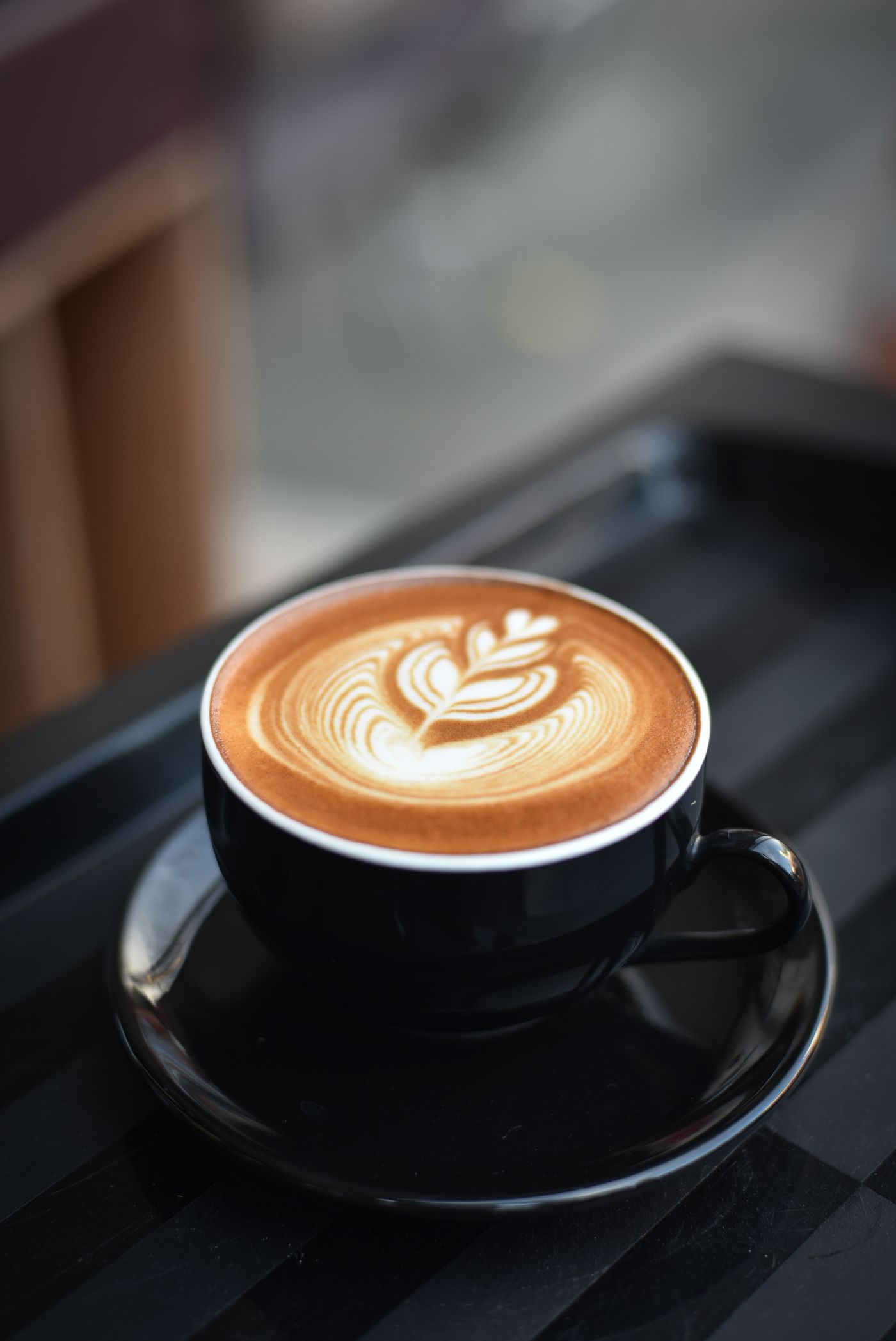 A cup of kopi on a kopitiam table
